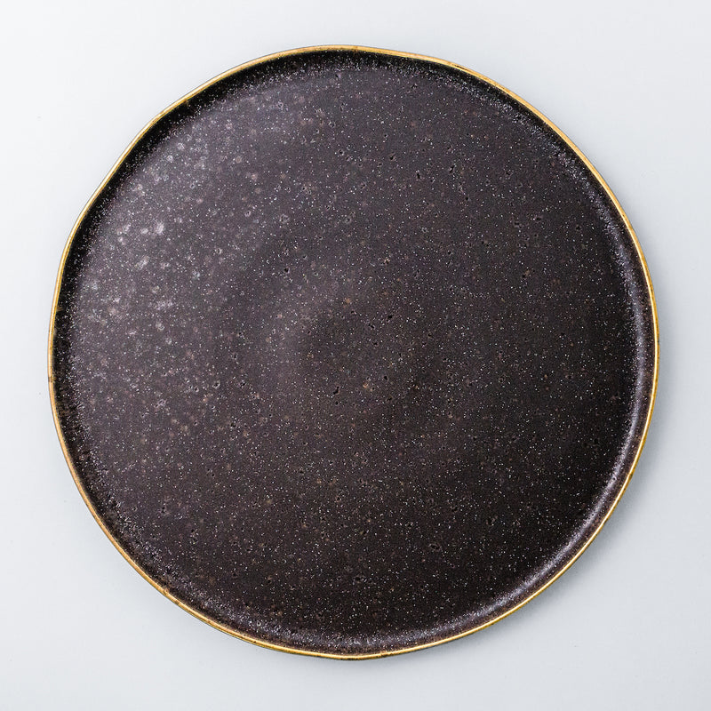 Charger plate. Rustic, yet chic and fancy dinnerware collection. Gold rim on the edge of each plate enhances irregularity of the shape and the organicity of the material.