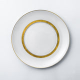 Salad plate. Dessert plate. Elegant and luxurious white dinnerware set with gold rim.