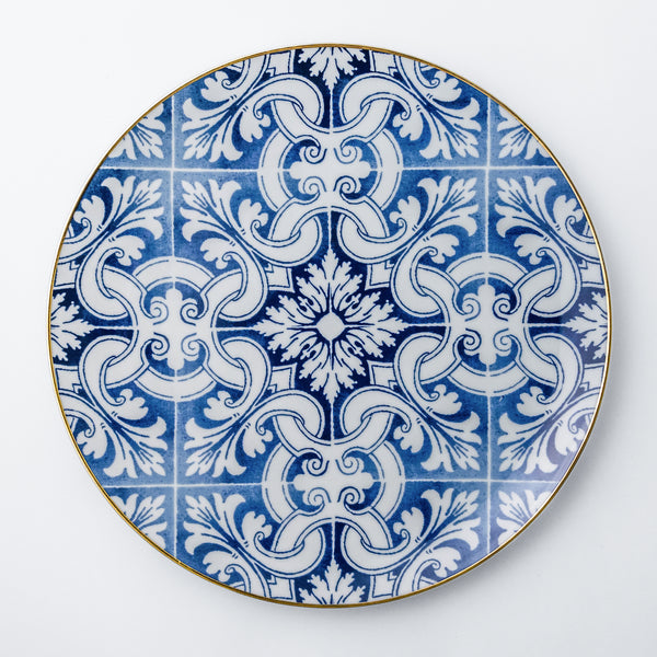 Charger plate. Exquisite dinnerware set with blue patterns and gold rim.