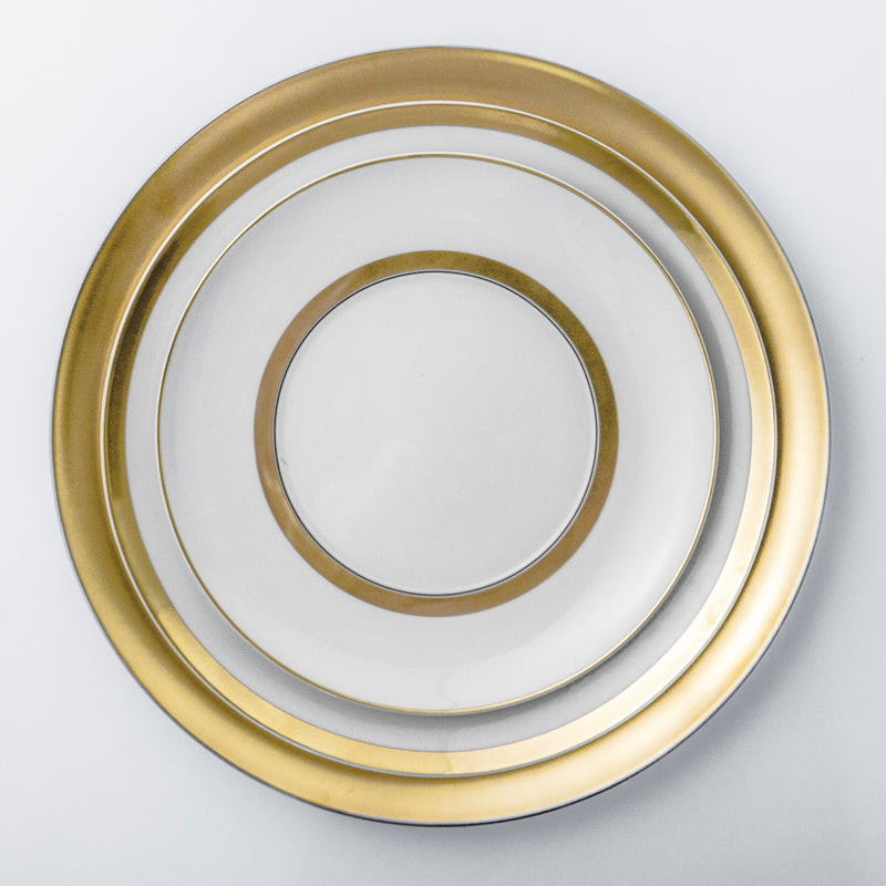 Elegant and luxurious white dinnerware set with gold rim.
