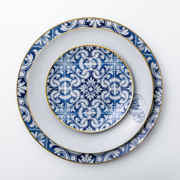 Exquisite dinnerware set with blue patterns and gold rim.