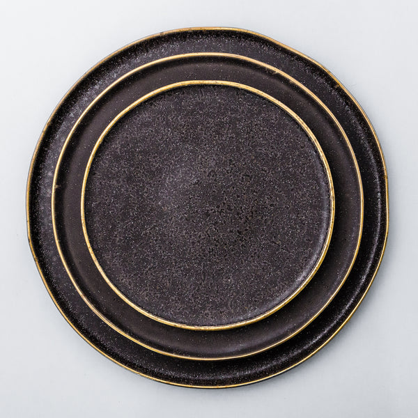 Rustic, yet chic and fancy dinnerware collection. Gold rim on the edge of each plate enhances irregularity of the shape and the organicity of the material.