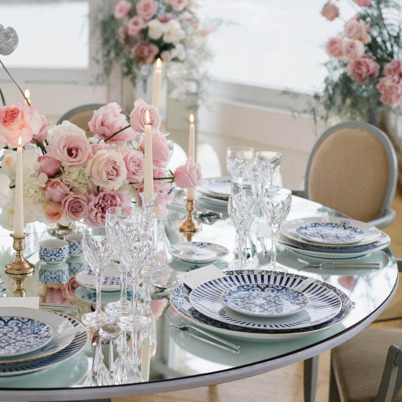 Exquisite dinnerware set with blue patterns and gold rim.